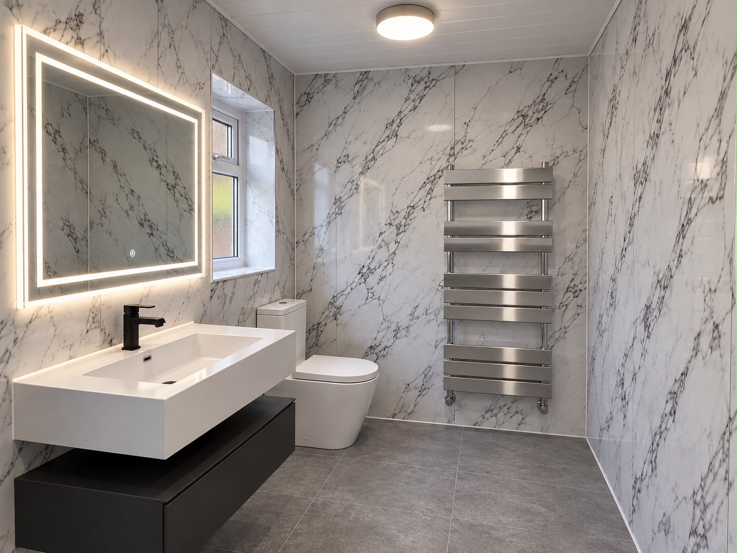 Modern bathroom installation featuring marble wall panels and floating vanity from near plumber.